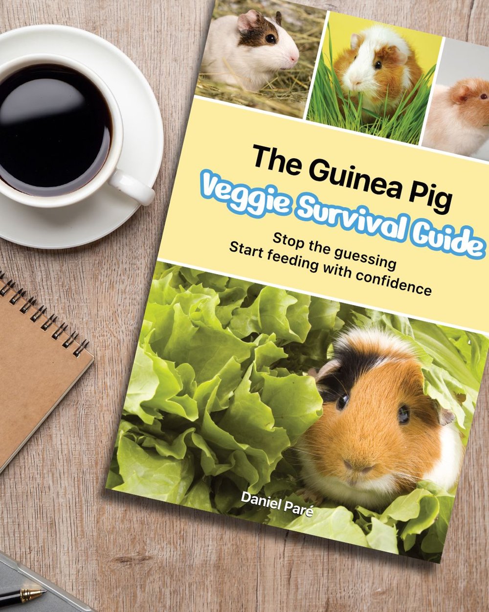 The Guinea Pig Veggie Survival Guide on a wooden desk next to a cup of coffee